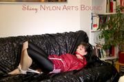 Mara tied and gagged on a black covered sofa wearing a supersexy red shiny nylon shorts over a leggings and a red rain jacket (Pics)