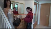 Jill ties, gagges and hoodes herself in front of a mirror and in an strairway wearing a sexy shiny nylon rain pants in black and a red rain jacket (Video)