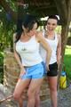 Jill and her friend having fun together outdoor both wearing shiny nylon shorts and a top (Pics)