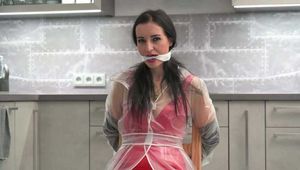  Miss Amira im sexy Lackkleid und Regenmantel wird gefesselt und geknebelt (hinter den Kulissen)