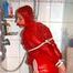 Stella tied and gagged under the shower wearing a shiny red nylon shorts and rain jacket (Pics)