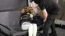 Marie bound and gagged in a shiny nylon Downjacket