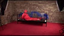 Jill tied, gagged and hooded on a princess bed wearing shiny orange rainwear (Video)