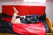 Simone tied and gagged in a big shiny nylon bag to lie in wearing a black shiny nylon shorts and a black shiny nylon rainjacket (Pics)