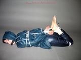 One of our archive girls tied and gagged in shiny nylon rainwear