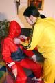 Jill tied by her friend in shiny yellow and red rainsuits