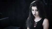 Goth girl with black eyes occasionally prefers dragging a 120mm cigarette