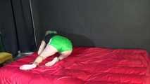 *** Sexy MIA wearing a green shiny nylon shorts and a black top ties and gagges herself with cuffs and a clothgag on a bed (Video)***