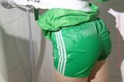 Sonja tied and gagged in a shower cabine with tape and rope wearing a very hot green shiny nylon shorts and a green rain jacket (Pics)