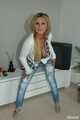 Busty Alexandra stripping out of a tight cardigan and blue jeans