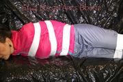 Mara tied, gagged and hooded with tape on a sexy black covered sofa wearing a supersexy grey rain pants and a pink rain jacket (Pics)