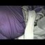 A video with Alina tied and gagged in a shiny purple and silver PVC suit