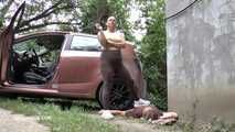 Mistress Jenna stands on the slave with a car while smoking in the slave's mouth A