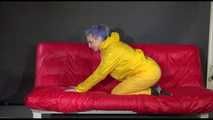 Watching Mara putting on sexy yellow shiny nylon rainwear lolling on the sofa (Video)