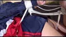***HOT HOT HOT*** PIA tied and gagged on a bed with ropes on the ceiling wearing sexy blue/red shiny nylon shorts and a white shirt (Video)