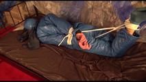 Alina tied, gagged and hooded on a princess bed in an old cellar wearing a shiny blue downwear (Video)