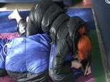 02:45 Min. video with a girl tied and gagged in a skisuit and a big shiny nylon bag to lie in from our archive