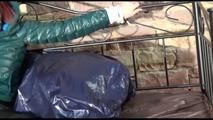 Mara tied and gagged on a princess bed in an old cellar wearing an supersexy shiny green down jacket and a rain pants (Video)