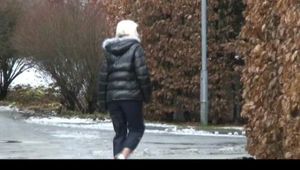 Blonde-haired archive girl going out wearing shiny nylon rainwear (Video)