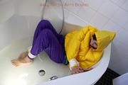 Julia tied and gagged in a ski suit in the bath tub