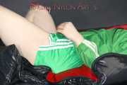 Lucy wearing sexy green shiny nylon shorts and a green rain jacket lolling on bed with a special cover (Pics)