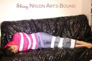 Mara tied, gagged and hooded with tape on a sexy black covered sofa wearing a supersexy grey rain pants and a pink rain jacket (Pics)