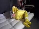 Watch Pia enjoying Bondage in her shiny nylon yellow Rainwear