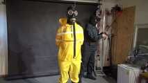 Watch Lady M bound in a yellow Rainsuit wearing a latex Hood and a Gasmask