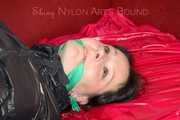 LUCY tied and gagged with ropes and a cloth gag on a sofa wearing a supersexy black shiny nylon shorts and black rain jacket (Pics)