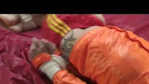 03:00 Min. video with Simone tied and gagged in shiny nylon shorts