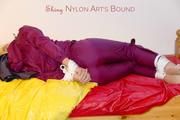 Pia in a shiny purple rainsuit tied and gagged in bed (Pics)