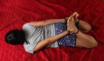 Ballgegged barefoot Lois in t-shirt and shorts, hog-cuffed on the floor with hinged cuffs, wiggles helplessly