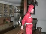 one of our archive girl tied and gagged in a shiny nylon rainsuit