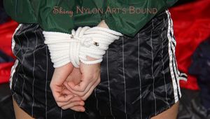 Samantha tied and gagged in bed wearing a black shiny nylon shorts and a green rainjacket (Pics)