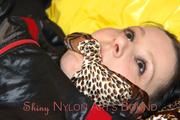 Lucy tied and gagged in a bed wearing a black shiny nylon downwear combination (Pics)