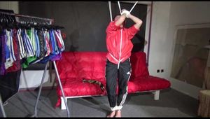 Sonja tied with ropes overhead and gagged wearing a sexy black rain pants and a special red rain jacket (Video)