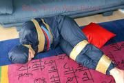 Jill tied, gagged and hooded on the floor with tape wearing an oldschool rain combination (Pics)
