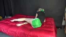 *** Sexy MIA wearing a green shiny nylon shorts and a black top ties and gagges herself with cuffs and a clothgag on a bed (Video)***