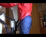 Watch Sonja to dress herself with rainwear and begin her workout on the home trainer (Video)