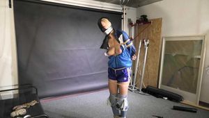 Myxxxy bound and gagged, wearing shiny nylon shorts and a windbreaker
