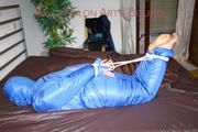 Jill tied, gagged and hooded on bed wearing a supersexy supershiny lightblue downwear (Pics)