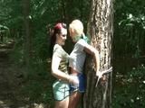 An archive girl tied and gagged on a tree by Jill both wearing shiny nylon shorts (Video)