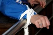 Jil tied and gagged in shiny nylon clothes