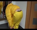 Jill wearing a yellow rain pants down jacket combination and rubber boots at home and outdoor (Video)