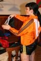 Jill wearing a sexy black nylon shorts and a orange rain jacket while dressing her up (Pics)