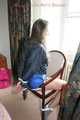 Stella being tied and gagged with ropes and a clothgag on a chair wearing a sexy shiny nylon short and a rain jacket (Pics)