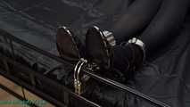 Nina heavyly cuffed to the bed