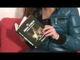 Alina wearing a sexy shiny crazy sensation skibib in blue and a green special down jacket reading on a sofa and playing with cuffs (Video)