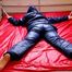 Pia hooded, tied and gagged on bed in a dark blue old school down ski suit