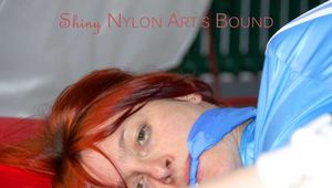 Sonja tied and gagged on bed with ropes wearing a sexy lightblue shiny nylon shorts and a lightblue rain jacket (Pics)